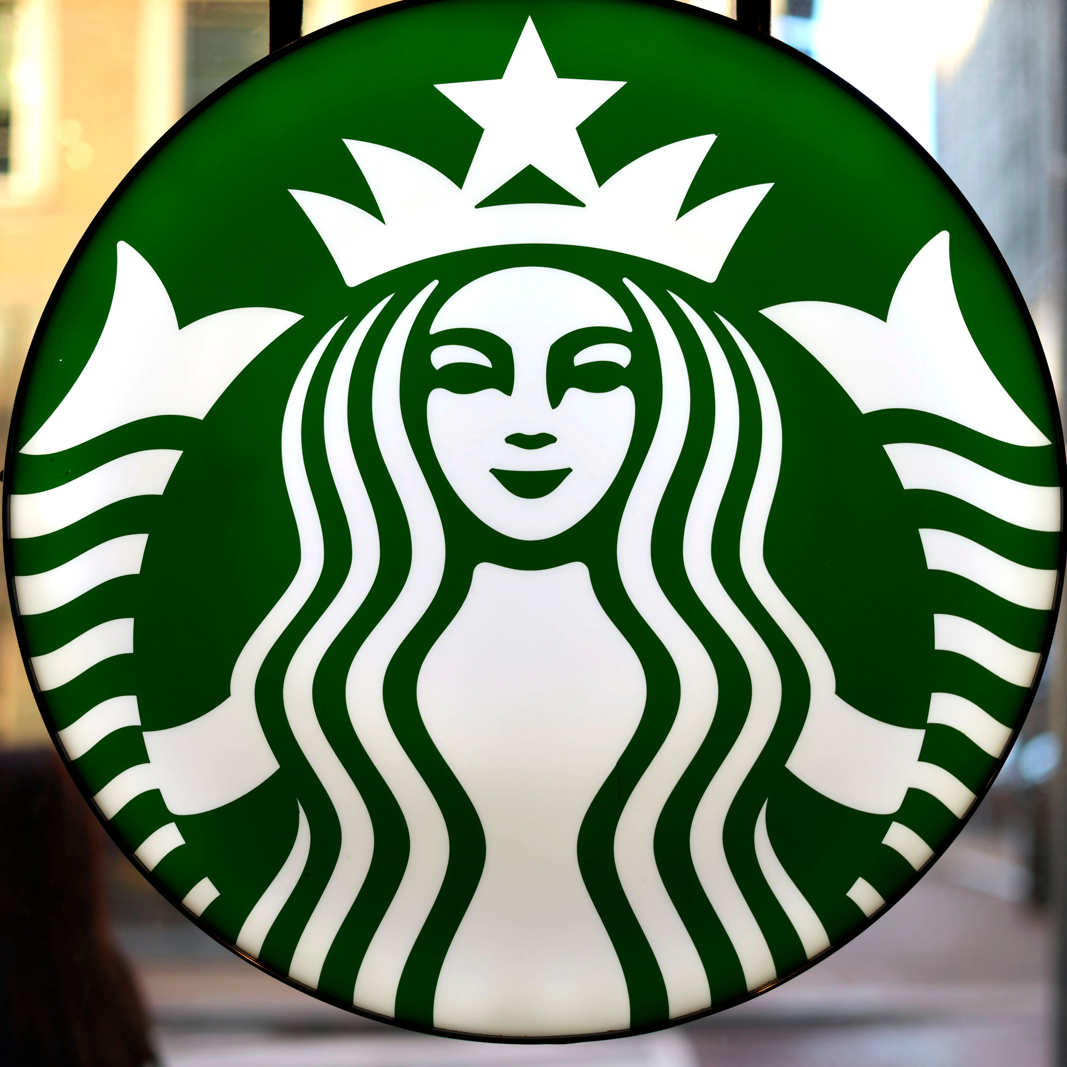 The Starbucks logo is displayed in the window of a downtown Pittsburgh Starbucks.