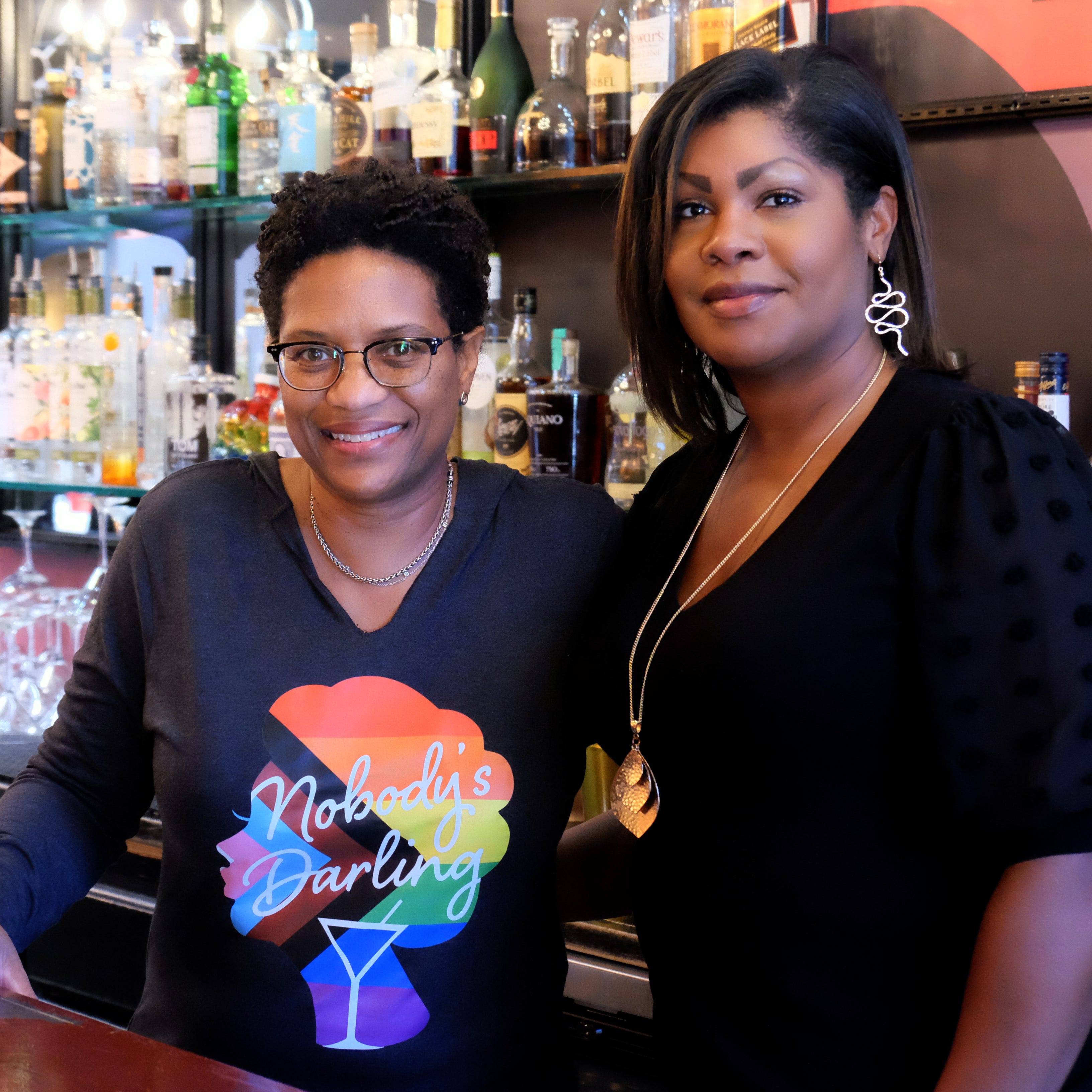 Angela Barnes, 54, (left) and Renauda Riddle, 42, (right) stand behind the bar of Nobody's Darling in Chicago, Illinois, on May 4, 2023.