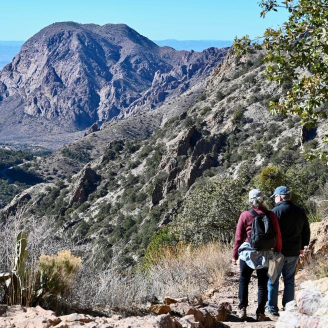 Hikers take in the view along the Chisos Basin of Big Bend National Park on January 25, 2023.