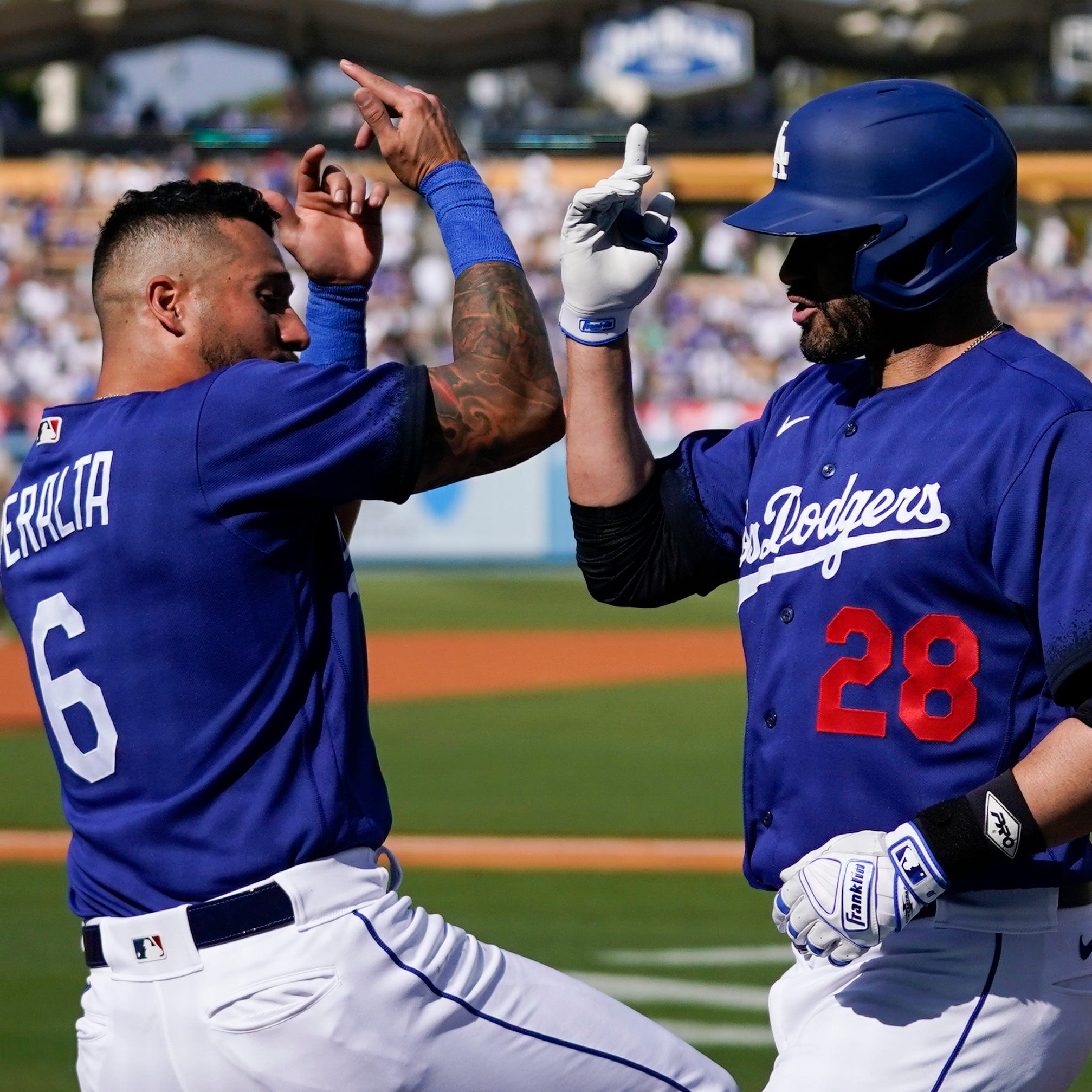 David Peralta and J.D. Martinez celebrate a home run against the Padres on Saturday at Dodger Stadium.