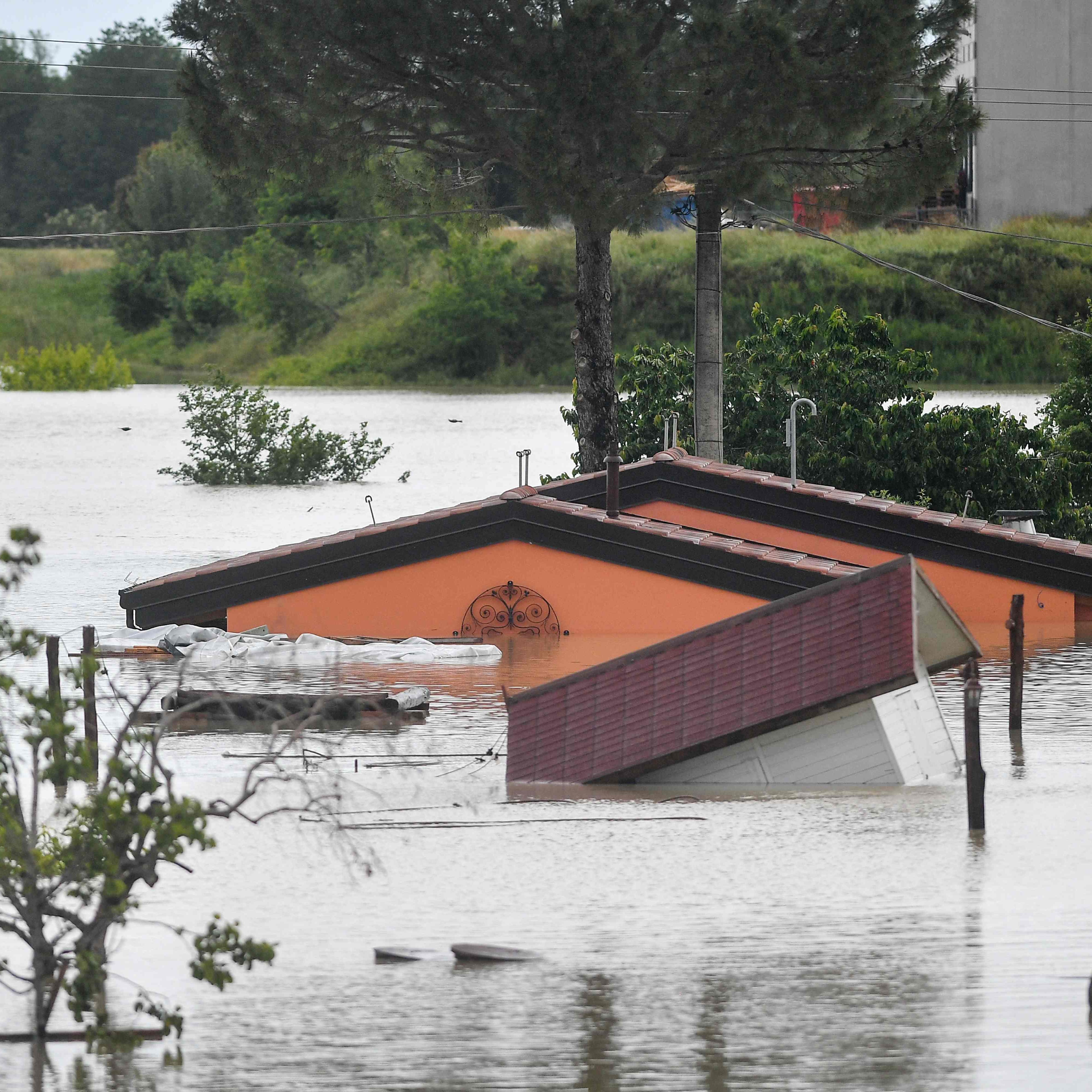 Flooded bungalows are pictured in Cesena on May 17, 2023 after heavy rains caused major floodings in central Italy. Trains were stopped and schools were closed in many towns while people were asked to leave the ground floors of their homes and to avoid going out, and five people have died after the floodings across Italy's northern Emilia Romagna region.