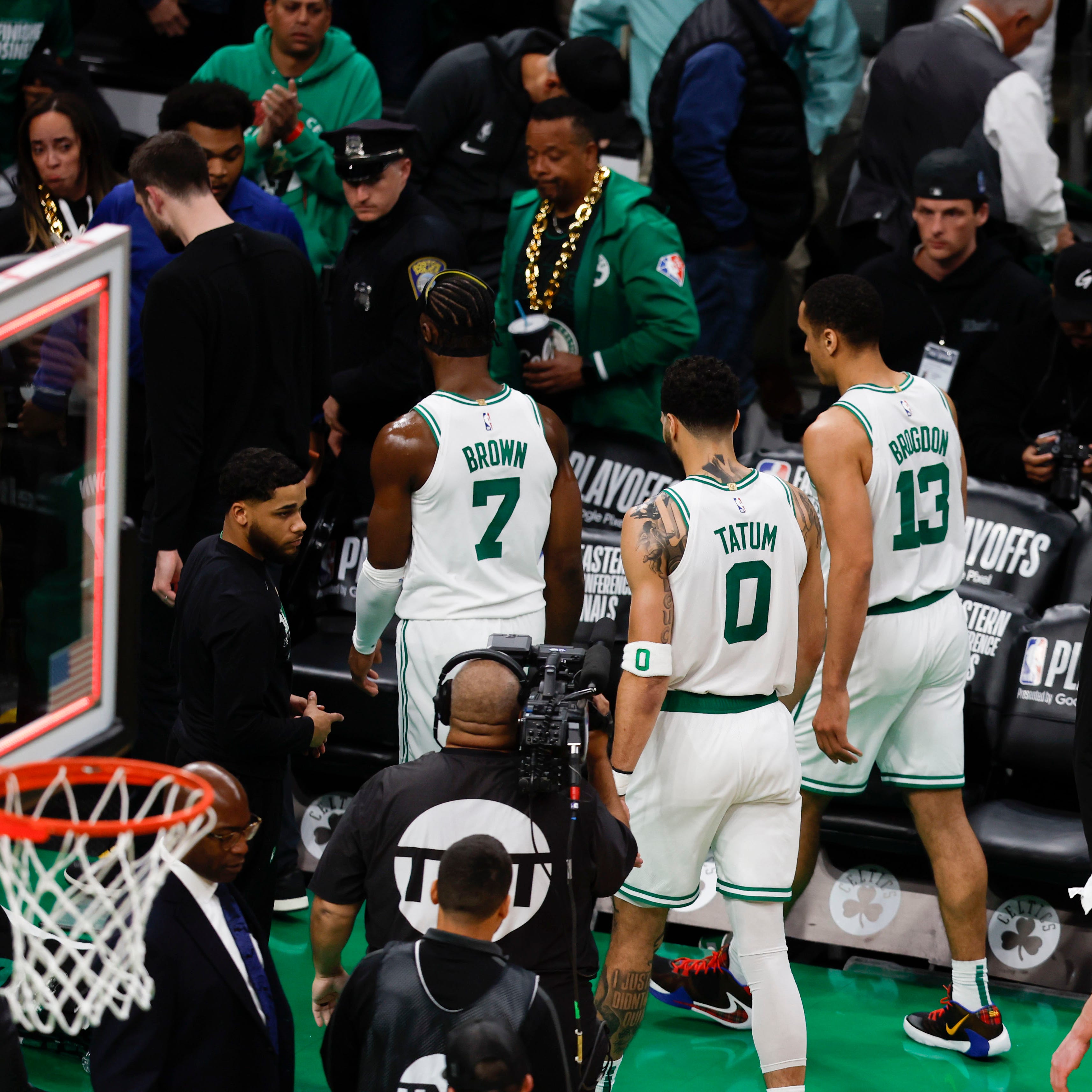 Jaylen Brown (7), Jayson Tatum (0) and Malcolm Brogdon (13) walk off the court after the Celtics lost Game 1 to the Heat.