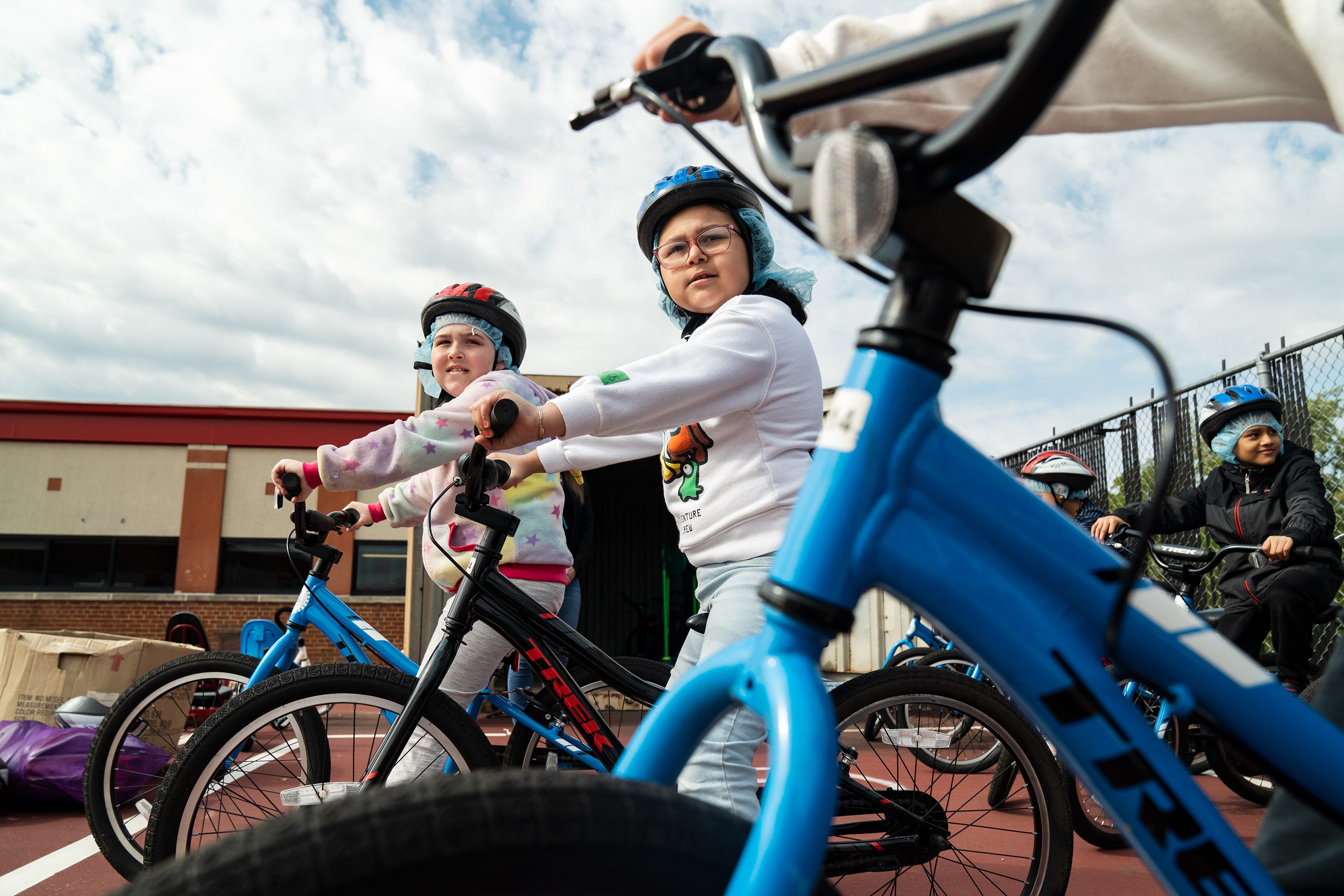 Ashley Soto, a third grader at Cora Kelly School in Alexandria, Va., listens to instructions with her classmates as they learn how to ride bikes during physical education.