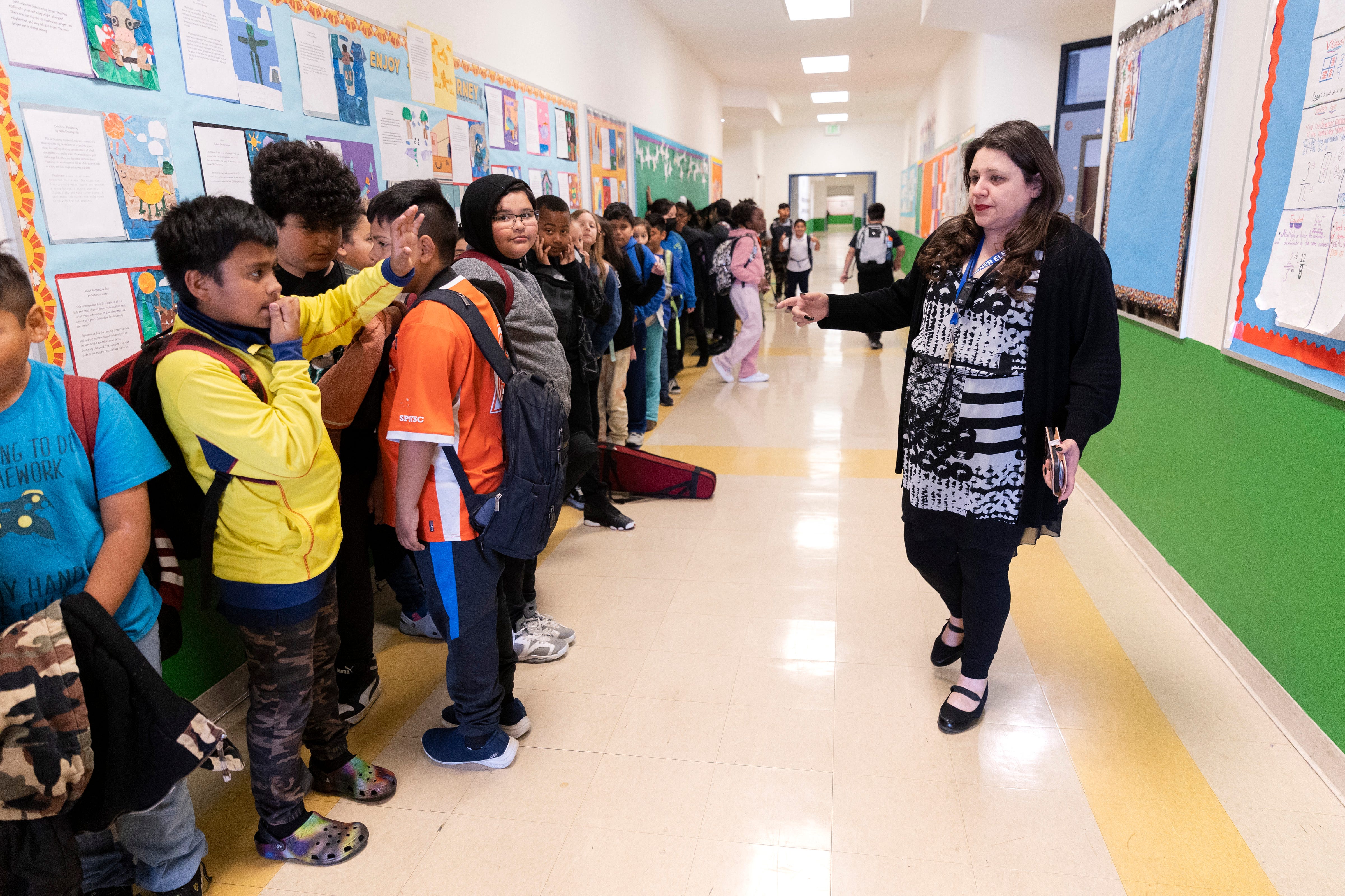 Teacher Wendy Gonzalez prepares to take a large group of students out to PE at Downer Elementary in San Pablo, Calif., because of the lack of substitute teachers.