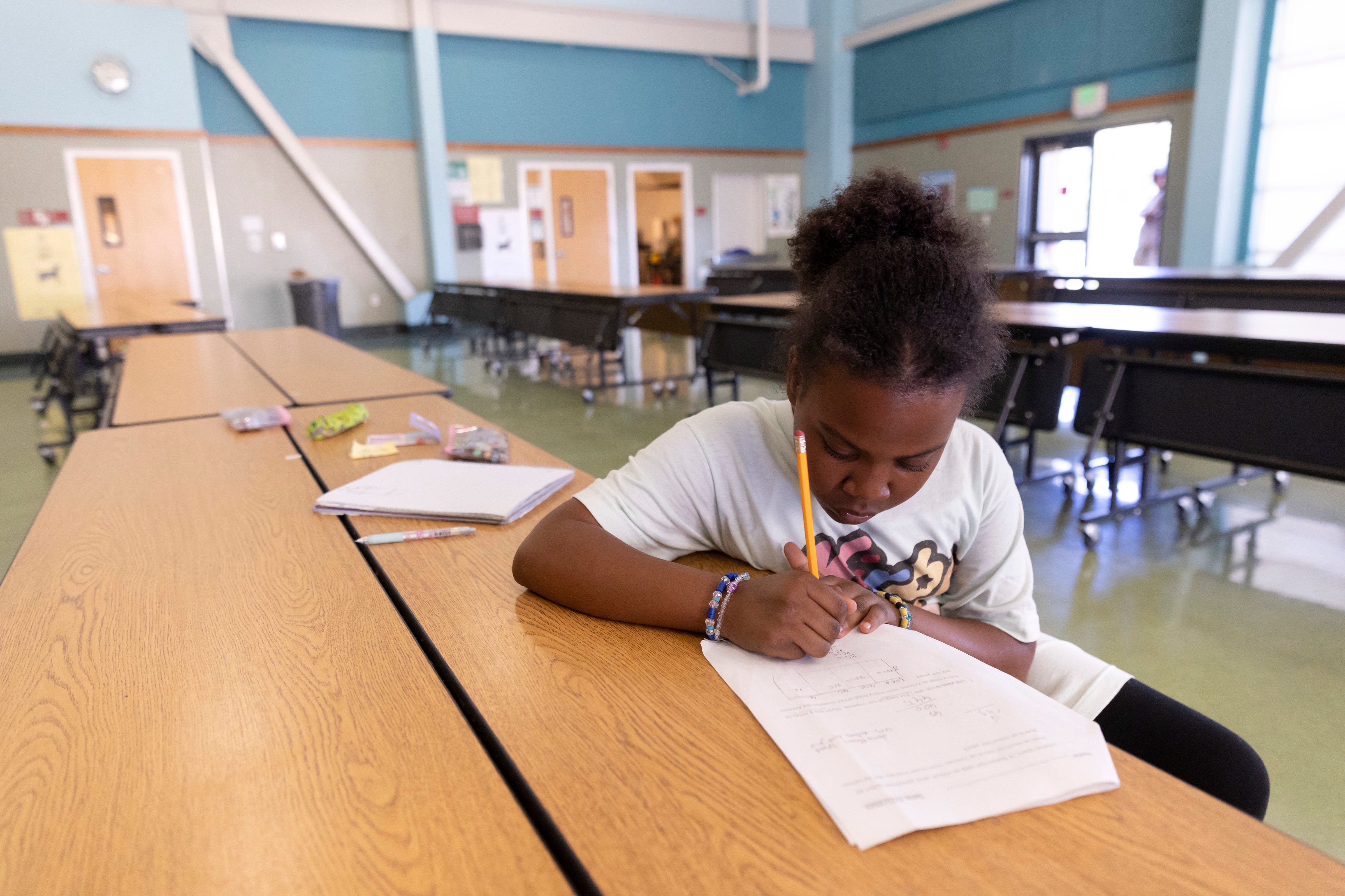 Jada Alexander works on her math homework in the cafeteria after school at Nystrom Elementary in Richmond, Calif.