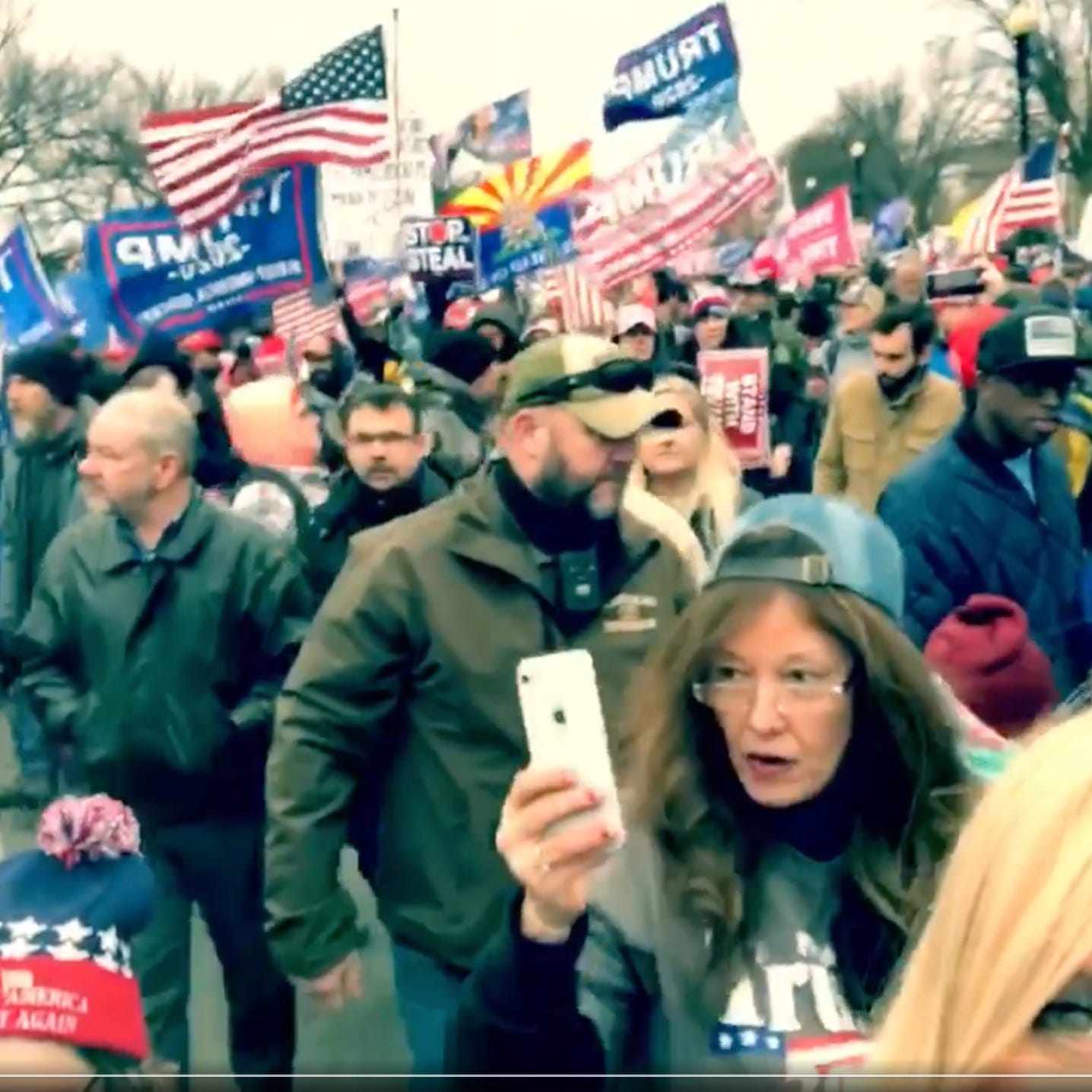 Sandra Atkinson marches through Washington, D.C., Jan. 6, 2021, in an image taken from video by Sherri Edwards Cox. A woman in the same clothing later appeared on surveillance video from inside the storming of the Capitol.