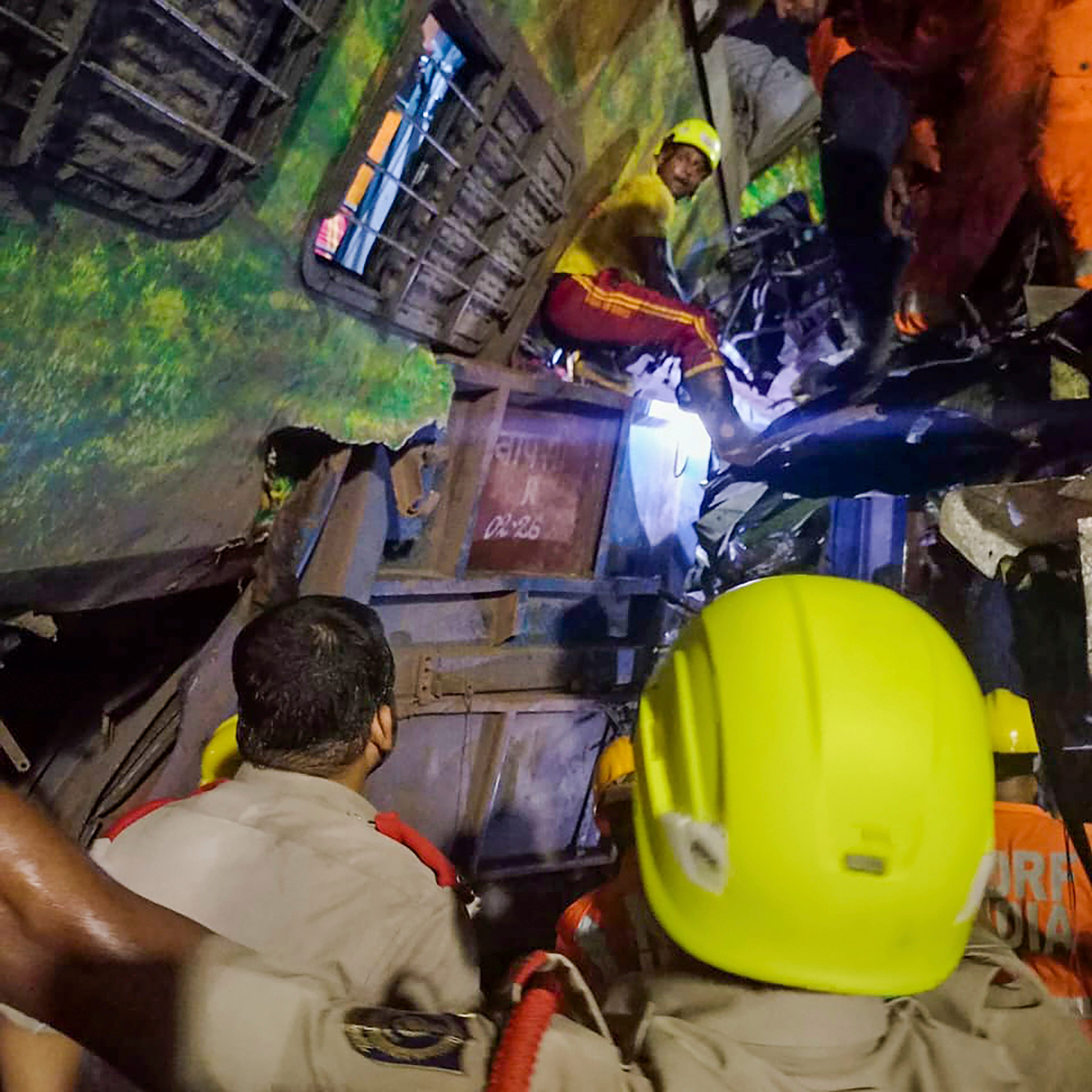 MANDATORY CREDIT- Rescuers work at the site of passenger trains that derailed in Balasore district, in the eastern Indian state of Orissa, Friday, June 2, 2023. Two passenger trains derailed in India, killing at least 13 people and trapping hundreds of others inside more than a dozen damaged coaches, officials said. About 400 people were injured and taken to hospitals, and the cause of the accident was under investigation, officials said. (Press Trust of India via AP)