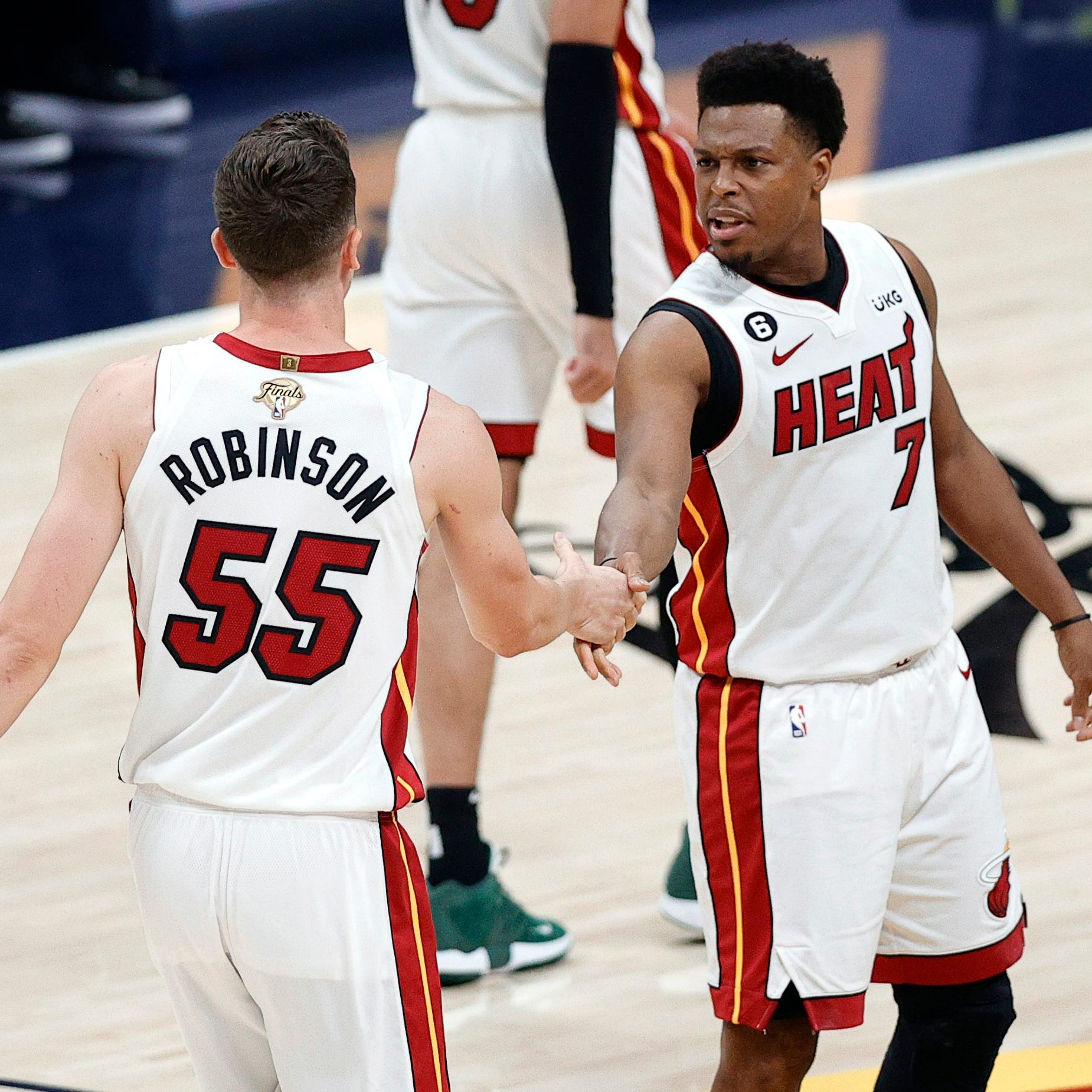 Miami Heat guard Kyle Lowry (7) and forward Duncan Robinson (55) celebrate a basket during Game 2 of the NBA Finals against the Denver Nuggets.