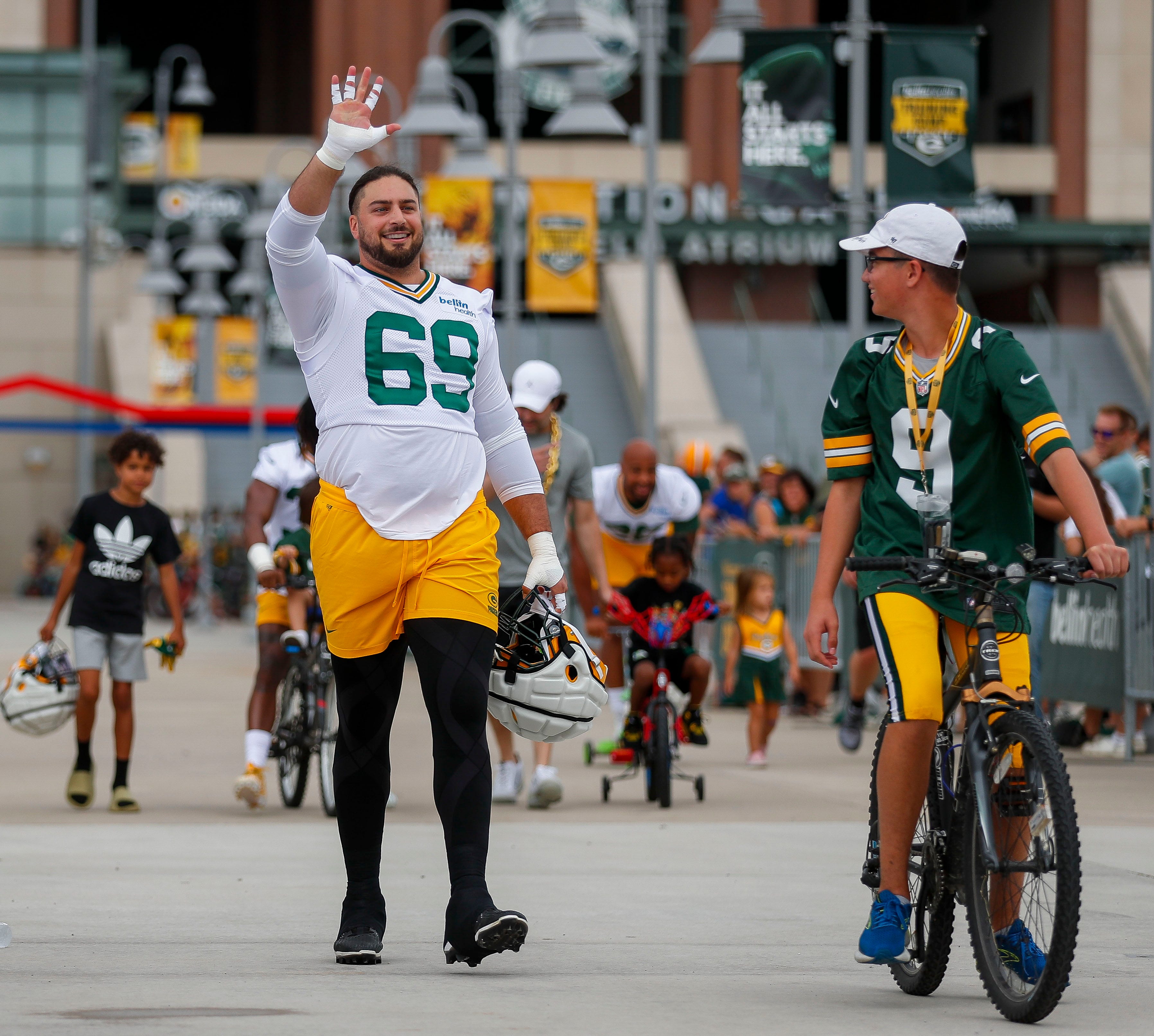 Green Bay Packers' Josh Boyd rides a bike to NFL football training