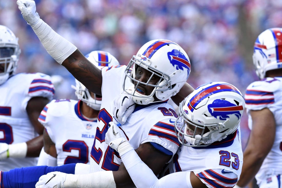 Vontae Davis (22) and fellow Buffalo Bills defensive back Micah Hyde (23) celebrate making a stop on third down during the first quarter against the Los Angeles Chargers at New Era Field.