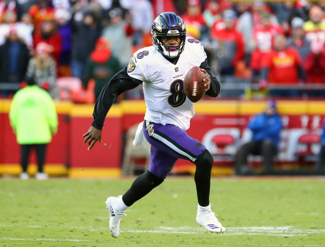 Baltimore Ravens quarterback Lamar Jackson (8) runs against the Kansas City Chiefs in overtime at Arrowhead Stadium on Sunday.