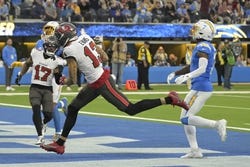 Dec 15, 2024; Inglewood, California, USA; Tampa Bay Buccaneers wide receiver Mike Evans (13) runs past Los Angeles Chargers cornerback Kristian Fulton (7) after a complete pass for a touchdown in the second half at SoFi Stadium. Mandatory Credit: Jayne Kamin-Oncea-Imagn Images